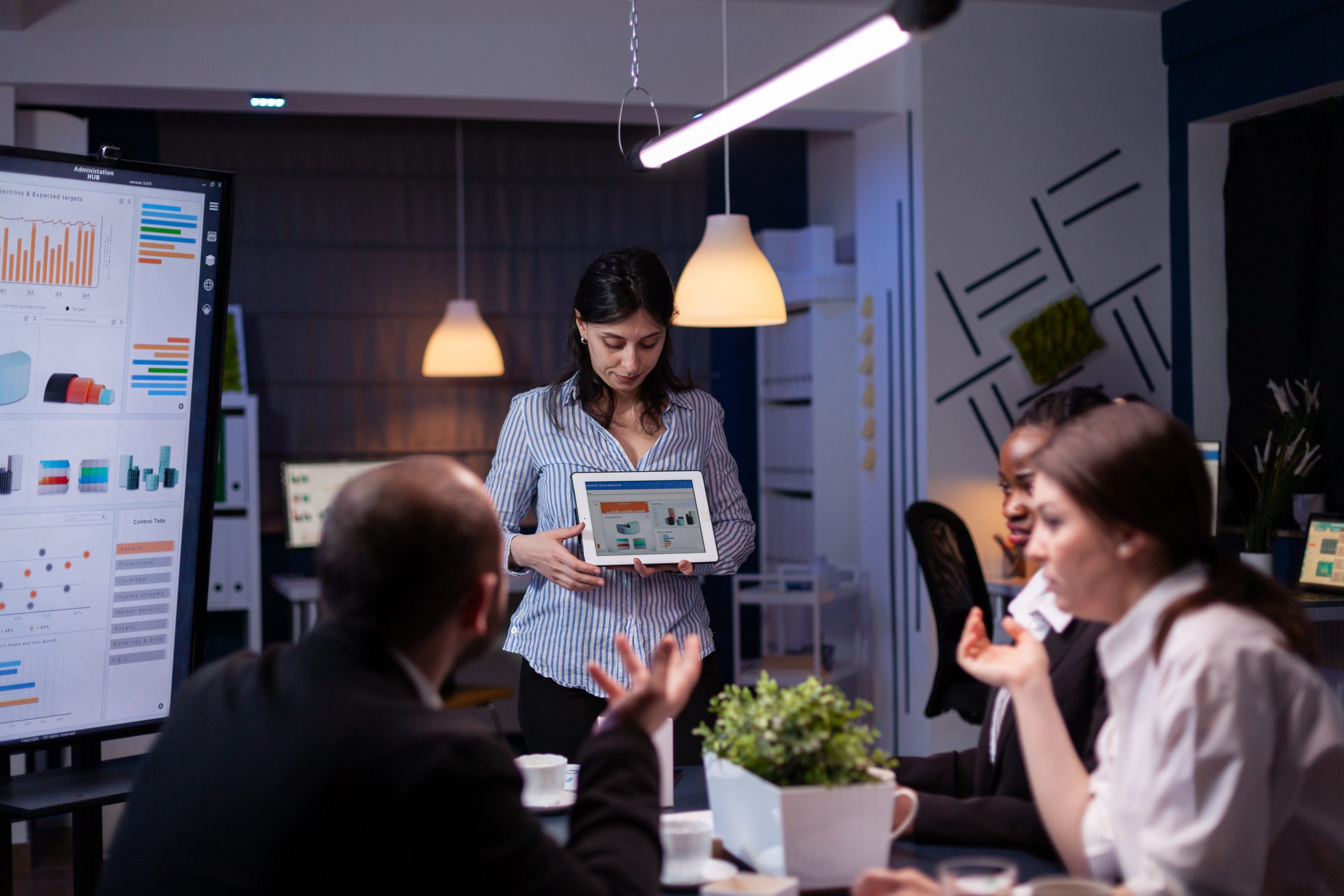 Overworked workaholic entrepreneur woman shwoing marketing graphs using tablet