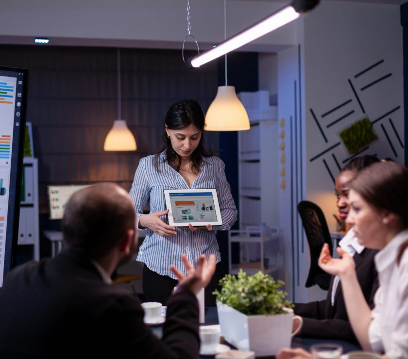 Overworked workaholic entrepreneur woman shwoing marketing graphs using tablet